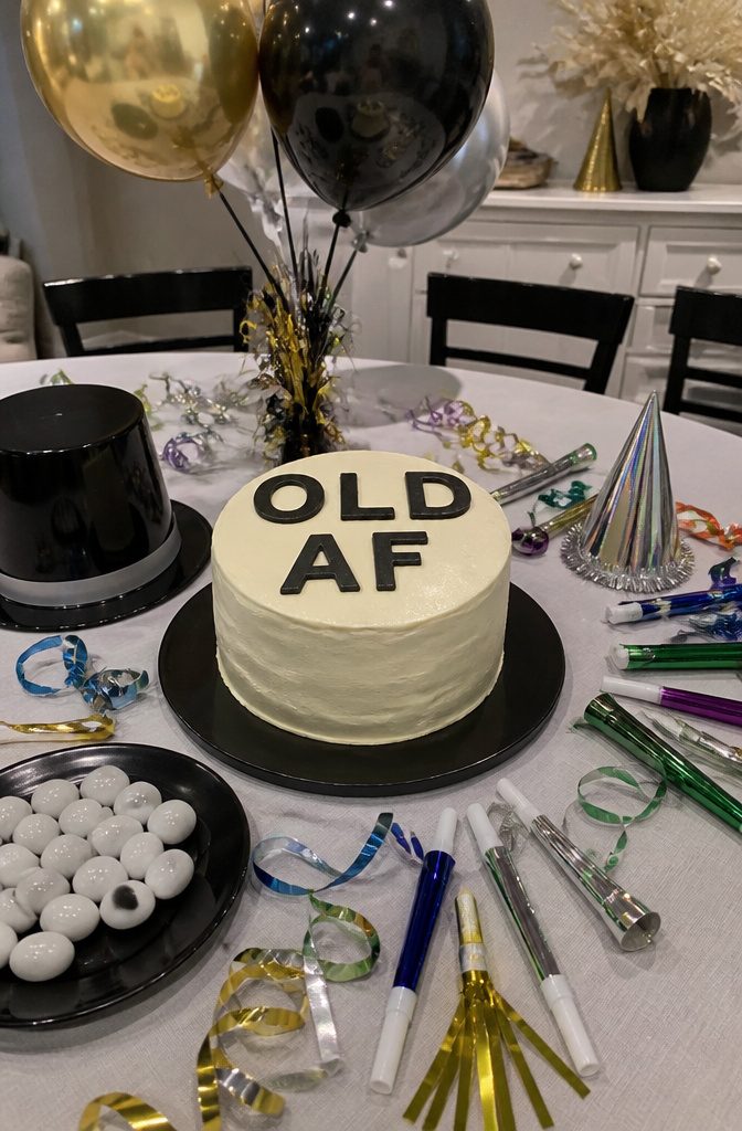 Cake with smooth icing and block lettering stating 'OLD AF'.